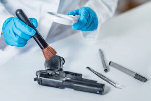 Forensic expert examining gun