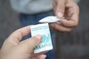 Hand of woman buying cocaine