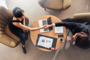 People shaking hands at a table