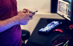 A man uses his smartphone to send a text message.