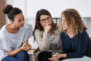 Sad woman crying during psychotherapy at professional clinic