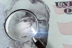 50 dollar bill under a magnifying glass